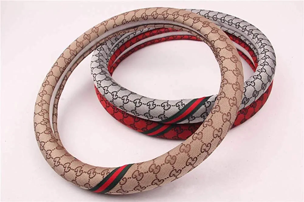 Slaycar Accessories - Multiple coloured LV and Gucci steering wheel cover  for that Pop of colour to your car interior . .Price 4,500 . . Visit Plot  60 Oredola Olojo Street by
